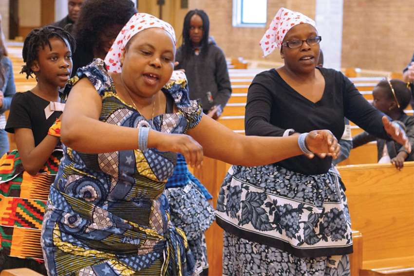 For Elizabeth Muturi, left, the sights and sounds of a Swahili Mass at St. Andrew’s in Edmonton were a dream come true.