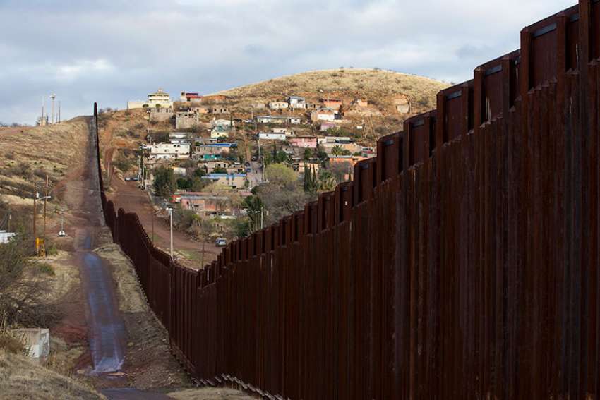 The bollard steel border fence splits the U.S. from Mexico in this view east of central Nogales, Ariz., Feb. 19.