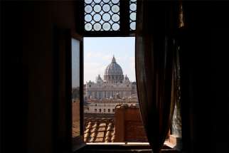 The dome of St. Peter&#039;s Basilica at the Vatican is seen through a window of Castel Sant&#039;Angelo in Rome in this 2018 file photo. On July 20, 2020, the Vatican issued a new instruction on pastoral care that emphasizes the role of lay men and women in the church&#039;s mission, but said most parishes must be led by priests.