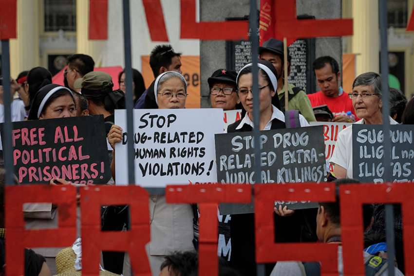 Nuns hold placards as they stage a demonstration to mark International Human Rights Day in Manila, Philippines, Dec. 10, 2016. 
