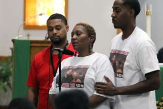 Vivian Carr and her sons Kenneth Johnston and Ellis Carr speak during a Sept. 23 prayer service at Our Lady of Consolation Catholic Church in Charlotte, N.C. The previous day Vivian&#039;s other son, Justin Carr, died from a gunshot wound to the head that he received during protests in Charlotte which turned violent following the fatal police shooting of an African-American man.