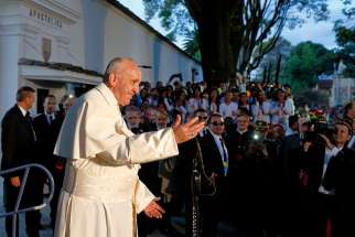 Pope Francis greets people outside the Apostolic Nunciature in Bogota, Colombia, Sept. 6. The pope plans to visit four Colombian cities during his six-day trip. 