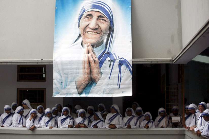 A poster of Blessed Teresa of Kolkata and Missionaries of Charity are seen in Calcutta, India, in this Sept. 5, 2007, file photo. Pope Francis will declare her a saint at the Vatican Sept. 4, the conclusion of the Year of Mercy jubilee for those engaged in works of mercy. 