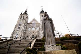 A statue of Jesuit martyr St. Jean de Brebeuf stands in front of the church at the Martyrs&#039; Shrine pilgrimage site in Midland, ON. The Canadian Jesuits run the shrine.