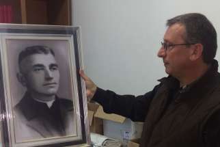 Franciscan Brother Vincenzo Foca holds a photo of Father Luigj Prendushi May 7 in Shkoder, Albania. Father Prendushi was killed in Albania under that country&#039;s former atheist regime and Brother Vincenzo has spent the last 24 years locating bodies of Catholics in Albania, some of whom, like Father Prendushi, are on Pope Francis&#039; list of martyrs.