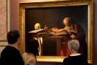 Visitors are pictured in a file photo looking at a Caravaggio painting titled &quot;St. Jerome Writing&quot; during an exhibition at the Galleria Borghese in Rome. Pope Francis released &quot;Scripturae Sacrae affectus&quot; (&quot;Devotion to Sacred Scripture&quot;), a new apostolic letter on the Bible, Sept. 30, 2020, coinciding with the 1,600th anniversary of St. Jerome&#039;s death.