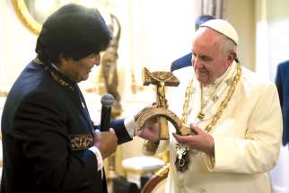 Bolivian President Evo Morales presents a gift to Pope Francis at the government palace in La Paz, Bolivia, July 8. The gift was a wooden hammer and sickle ­— the symbol of communism — with a figure of a crucified Christ. 
