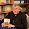 Toronto Archbishop Thomas Collins poses with a copy of his new book, Pathway to our Hearts.