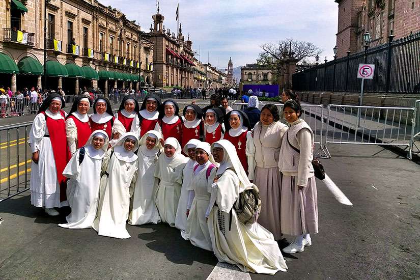 Women religious pose for a photo outside the Cathedral of Morelia in the state of Michoacan, Mexico, Feb. 15. Pope Francis will visit the church prior to his meeting with youth.