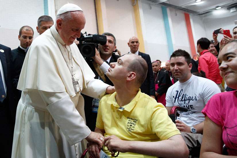 Pope Francis greets a young man during a meeting with youth at the diocesan John Paul II Youth Center in Sarajevo, Bosnia-Herzegovina, June 6. The pope made a one-day visit to Bosnia-Herzegovina to encourage the minority Catholic community in the faith and to foster dialogue and peace in a nation still largely divided along ethnic lines.