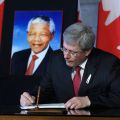 Canadian Prime Minister Stephen Harper signs a book of condolence for former South African President Nelson Mandela on Parliament Hill in Ottawa Dec. 6. Mandela, who led the struggle to replace his country&#039;s apartheid regime with a multiracial democracy, died Dec. 5 at age 95 at his home.