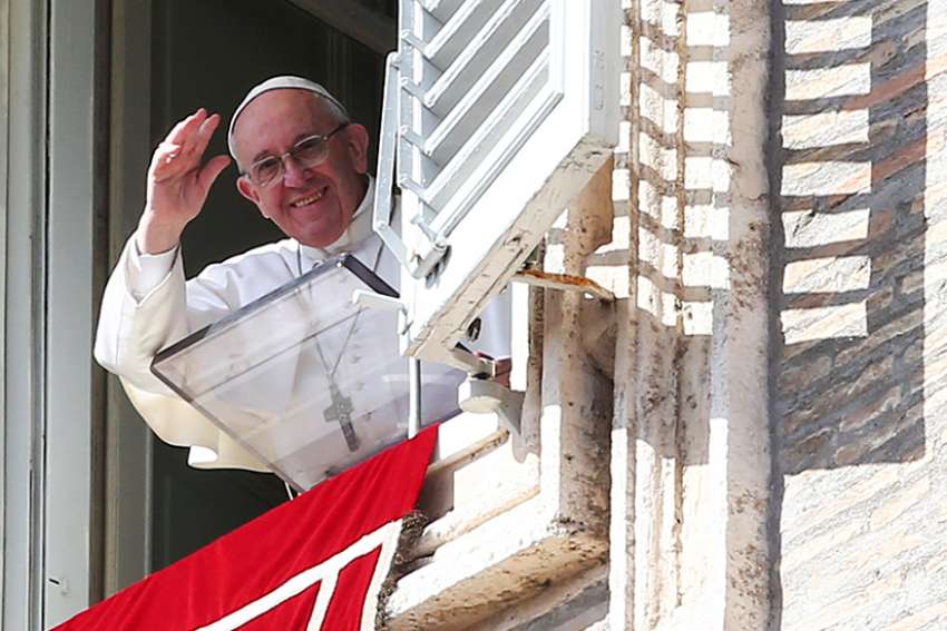 Pope Francis waves as he leads the Angelus from his studio overlooking St. Peter&#039;s Square Feb. 26 at the Vatican.