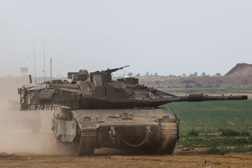 An Israeli tank re-enters Israel from Gaza near the Israel-Gaza border in southern Israel Jan. 11.