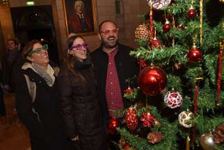 Galit Oren, Tali Khanin, and Zohar Kaplan wear special glasses that make the lights multiply on the Christmas tree in the lobby of the YMCA in West Jerusalem Christmas Eve. They were part of a group of secular rabbinical students who had come to experience Christmas in Jerusalem.
