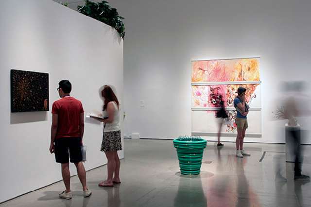 Patrons peruse the artwork in “Back to Eden: Contemporary Artists Wander the Garden,” an exhibit at New York’s Museum of Biblical Art.