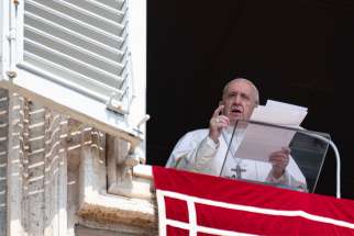 Pope Francis greets the crowd as he leads the Angelus from the window of his studio overlooking St. Peter&#039;s Square at the Vatican Aug. 25, 2019.