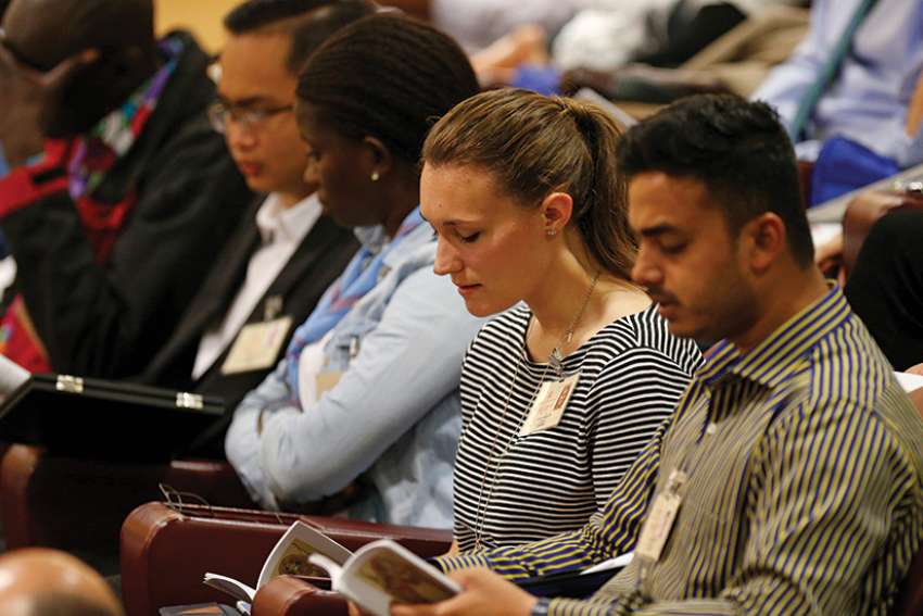 Emilie Callan, a synod delegate from Canada, second from right, attends a session of the Synod of Bishops on young people, the faith and vocational discernment at the Vatican Oct. 11.