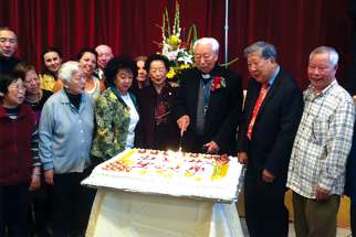 Fr. Thomas Tou cuts the cake at his 94th birthday celebration.