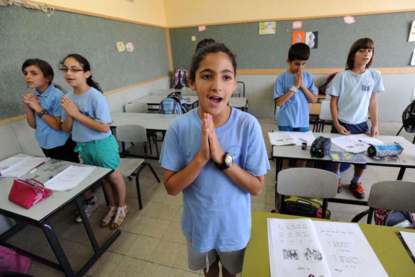 Israeli-Arab fourth-grade students pray in Aramaic during language class in 2012 at Jish Elementary School in Israel. Dozens of Christian schools in Israel may be shutting their doors this coming school year due to increasing restrictions by the Israeli government, Christian educators warn.