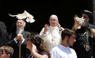 Pope Francis and Pope Tawadros II of Alexandria, patriarch of the Coptic Orthodox Church, right, release doves as they stand with Ecumenical Patriarch Bartholomew of Constantinople outside the Basilica of St. Nicholas in Bari, Italy, July 7. The Pope was meeting with Christian leaders for an ecumenical day of prayer for peace in the Middle East. 