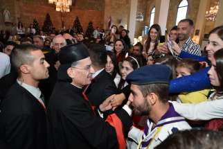 Lebanese Cardinal Bechara Rai, patriarch of the Maronite Catholic Church, greets people after celebrating Mass Dec. 7 at Our Lady of the Annunciation Cathedral in Tartus, Syria. He urged Syrian Christians to hold onto their faith amid the country&#039;s conflict, now in its fifth year.