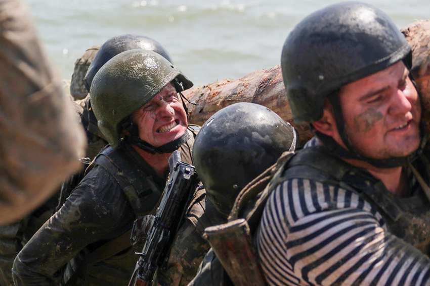 Young Ukrainian Marine recruits are seen on the obstacle course during their training in late May at a shooting range near Mariupol. 