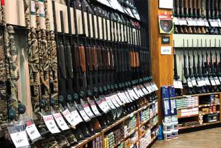 Rifles are seen inside the gun section of an American sporting goods store.