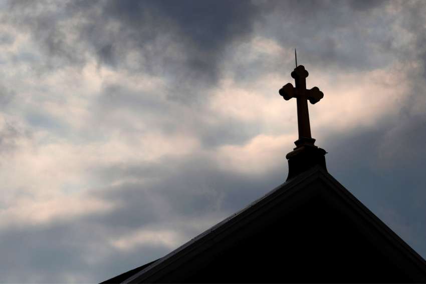 Storm clouds pass over a a Catholic church in Pittsburgh.