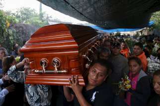 The coffin of Gisela Mota, former mayor of Temixco, Mexico, is carried out of her home Jan. 3. Mota was killed Jan. 2, one day after taking oath of office.