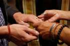 A same-sex couple is pictured in a file photo exchanging rings during a ceremony in Salt Lake City. The Vatican&#039;s doctrinal office says in a new note that any form of blessing of same-sex unions is &quot;illicit,&quot; but that the negative judgment is on the blessing of unions, not the people, who must be respected.