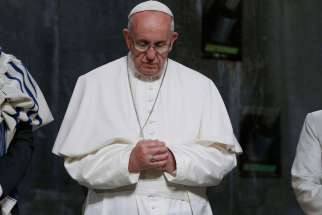 Pope Francis praying in 2015