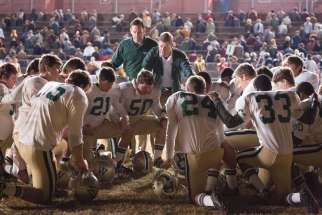 The Woodlawn High School football team, led by defensive co-ordinator Jerry Stearsn (Kevin Sizemore), top left, and head coach Tandy Geralds (Nic Bishop), pause to pray before an important game.