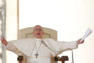 Pope Francis makes a gesture of an embrace during his general audience in St. Peter&#039;s Square at the Vatican Sept. 27. 