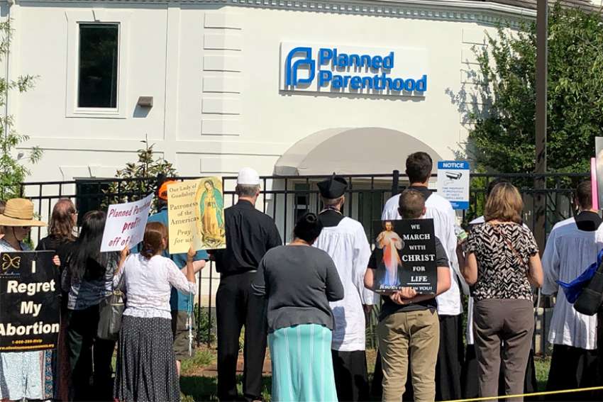 Catholics pray for an end to abortion during a June 15, 2019, procession and rally outside Planned Parenthood&#039;s new location in Charlotte, N.C. The facility is larger than its previous location and is located in a historically African American neighborhood of Charlotte. Pro-life groups, grassroots organizations and churches have united in opposition to the new location.