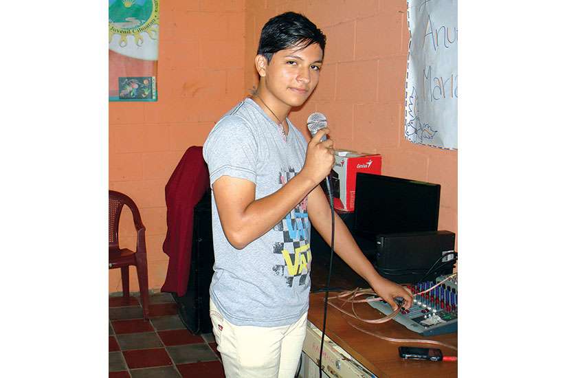 Melvin Menjivar prepares to go on air at Radio Positiva in Marianella Garcia Villa, El Salvador.