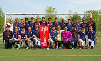 The Bishop Marrocco/Thomas Merton Royals with their 2016 TDCAA Senior Boys Championship banner. They are running a one-week soccer camp for youths in the troubled Attawapiskat community in late June. 