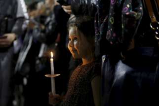 A girl attends a candlelight vigil in San Bernardino, Calif., Dec. 3 for the victims of a mass shooting the previous day at the Inland Regional Center. At least 14 people were killed when gunmen opened fire during a function at a center for people with developmental disabilities.