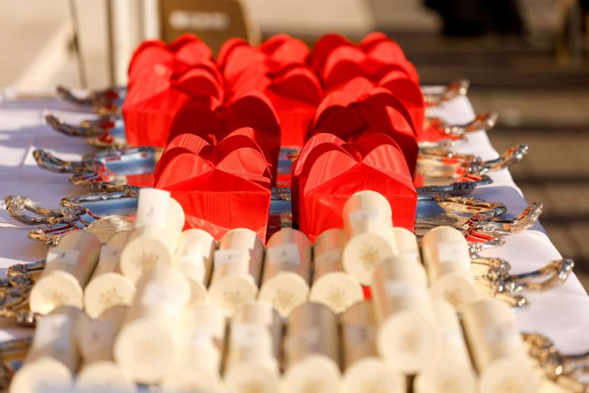Red birettas and scrolls lie on a table before Pope Francis distributes them to new cardinals at a consistory in St. Peter&#039;s Square at the Vatican Sept. 30, 2023.