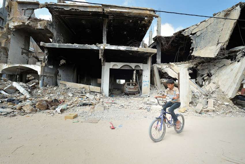 Scenes like this bombing aftermath in Gaza challenge us to reconcile the allloving God with the tragedies of the world.