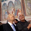 Israeli President Shimon Peres, center, looks at frescos as he visits the Basilica of St. Francis of Assisi in Assisi, Italy, May 1. Pope Francis urged Israelis and Palestinians to resume talks and make &quot;courageous decisions&quot; to bring peace after his fir st meeting with Peres the previous day. The pope also accepted an invitation to visit the Holy Land.