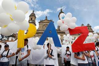 People form the word peace outside the cathedral in Bogota, Colombia, Sept. 26, 2016. To chants of &quot;No more war,&quot; the Colombian government and Marxist rebels signed an agreement that day to end Latin America&#039;s last armed conflict.