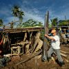 Two days after Typhoon Bopha raged through the southern Philippines island of Mindanao, Ignacio Carcosa cleans up the rubble of his home damaged by flood waters, in Cagayan de Oro Dec. 7.