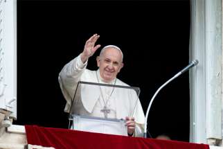 Pope Francis greets the crowd as he leads the &quot;Regina Coeli&quot; from the window of his studio overlooking St. Peter&#039;s Square at the Vatican May 2, 2021.