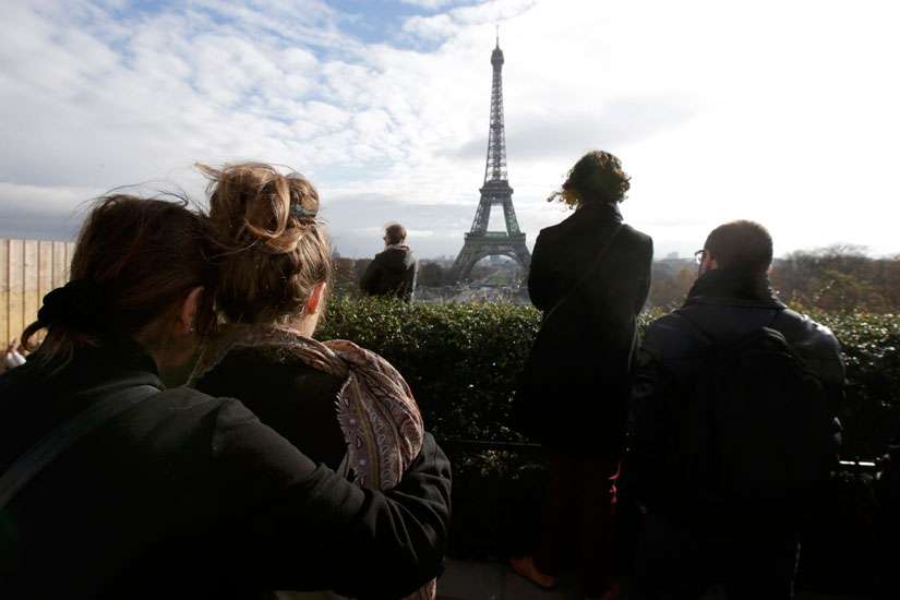 People observe a minute of silence at the Trocadero in Paris Nov. 16.