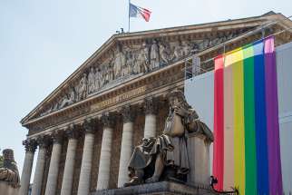 The LGBT rainbow flag is displayed on the facade of the National Assembly in Paris.