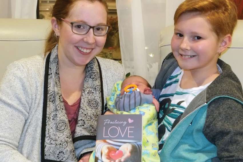 Leah Perrault and daughter Robyn (holding baby brother Atticus) of Holy Family Cathedral Parish in Saskatoon worked together to write a Lenten resource for families entitled Practicing Love. 