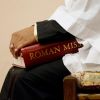 An altar server holds a copy of the new English translation of the Roman Missal during Mass. The new missal was used for the first time in churches across the nation on the first Sunday of Advent 2011. 