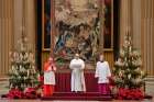 Pope Francis delivers his Christmas message and blessing &quot;urbi et orbi&quot; (to the city and the world) from the Hall of Blessings at the Vatican Dec. 25, 2020. Also pictured are Cardinal Angelo Comastri, archpriest of St. Peter&#039;s Basilica, and Msgr. Guido Marini, papal master of ceremonies.