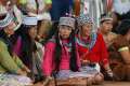  Young members of an indigenous group from the Amazon region listen during a meeting with Pope Francis Jan. 19 at Madre de Dios stadium in Puerto Maldonado, Peru.