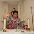 Dorothy Loreen prepares the altar in Sr. Fay Trombley’s house for about two dozen Catholics in Tuktoyuktuk.The community gathers in Trombley’s house while Our Lady of Grace Church undergoes repairs.